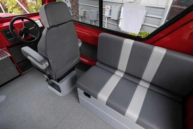 Slide: The Image of Interior of 2026 Hewescraft 240 Ocean Pro ET Hardtop, featuring gray seating and steering area. - 13