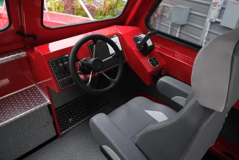 Slide: The Image of Interior of 2026 Hewescraft 240 Ocean Pro ET Hardtop, featuring red dashboard and gray seating. - 14