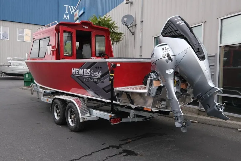 Slide: The Image of 2026 Hewescraft 240 Ocean Pro ET Hardtop boat on trailer, red exterior, powerful outboard motor. - 5