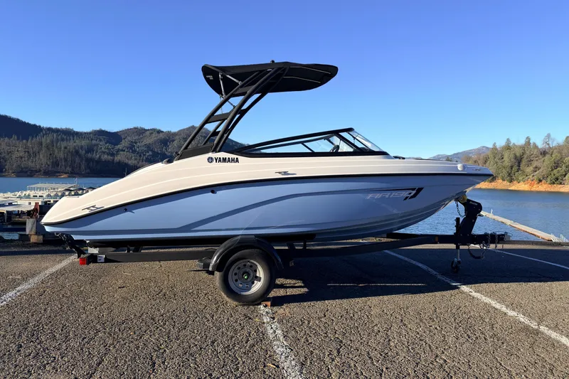 The Image of 2025 Yamaha Boats AR190 on trailer by scenic lake and mountains. - 16