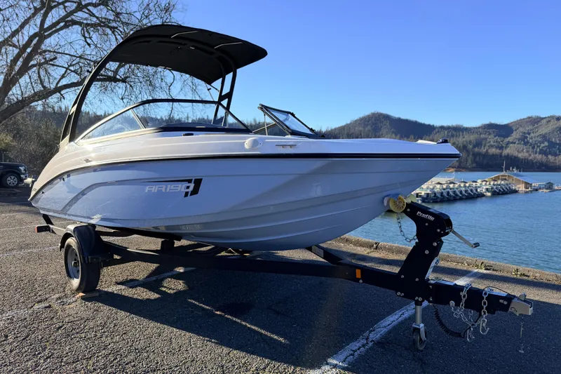Slide: The Image of 2025 Yamaha Boats AR190 on trailer by scenic lake and mountains. - 21