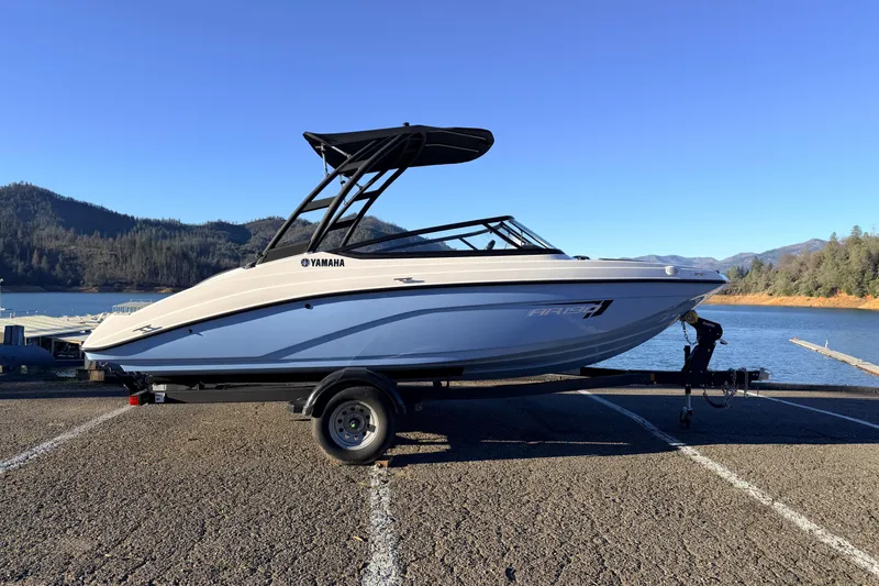 Slide: The Image of 2025 Yamaha Boats AR190 on trailer by scenic lake and mountains. - 22