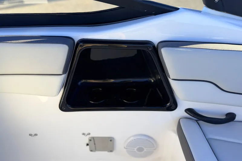 Slide: The Image of 2025 Yamaha Boats AR190 interior detail with cup holders and speaker. - 35