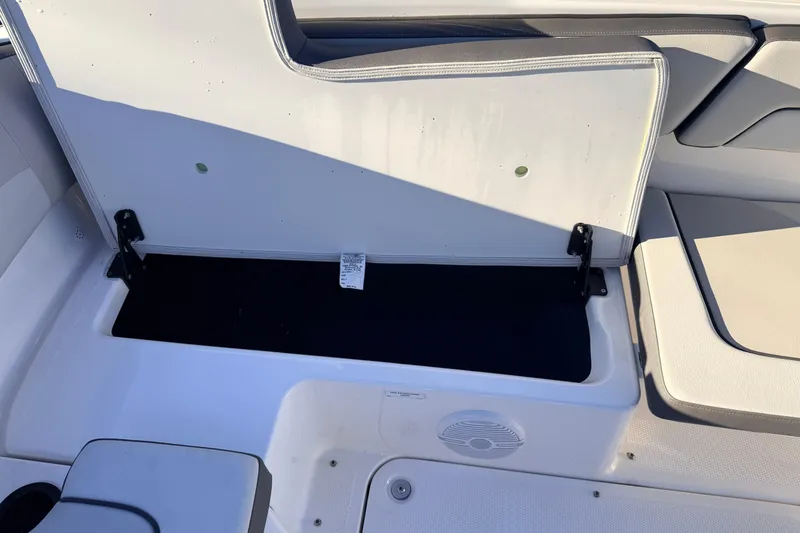 Slide: The Image of 2025 Yamaha Boats AR190 storage compartment with open seat, showcasing interior space. - 37