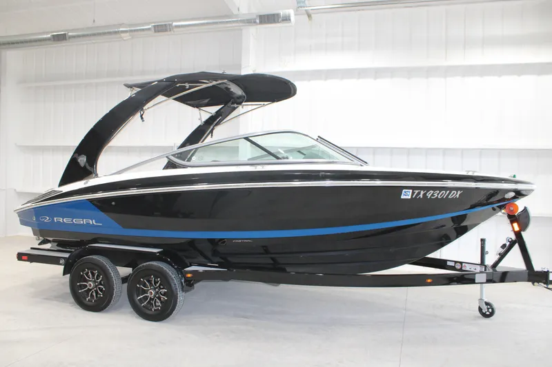 The Image of 2017 Regal 2100 Bowrider boat on trailer in indoor showroom. - 0