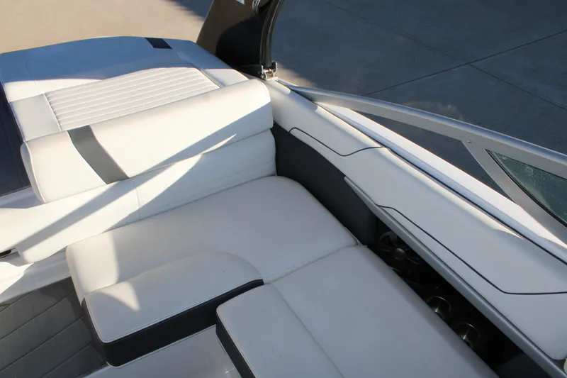 Slide: The Image of 2017 Regal 2100 Bowrider interior with white cushioned seating and sleek design. - 11