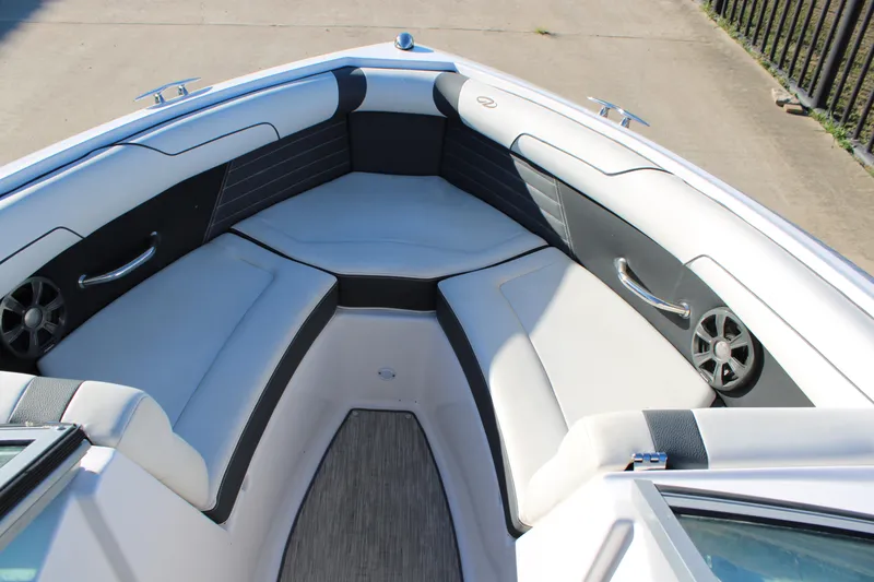 Slide: The Image of 2017 Regal 2100 Bowrider boat interior with cushioned seating and speakers. - 13