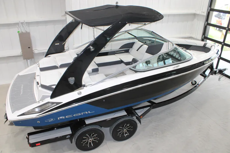 Slide: The Image of 2017 Regal 2100 Bowrider boat with sleek design, black hull, and spacious seating. - 18