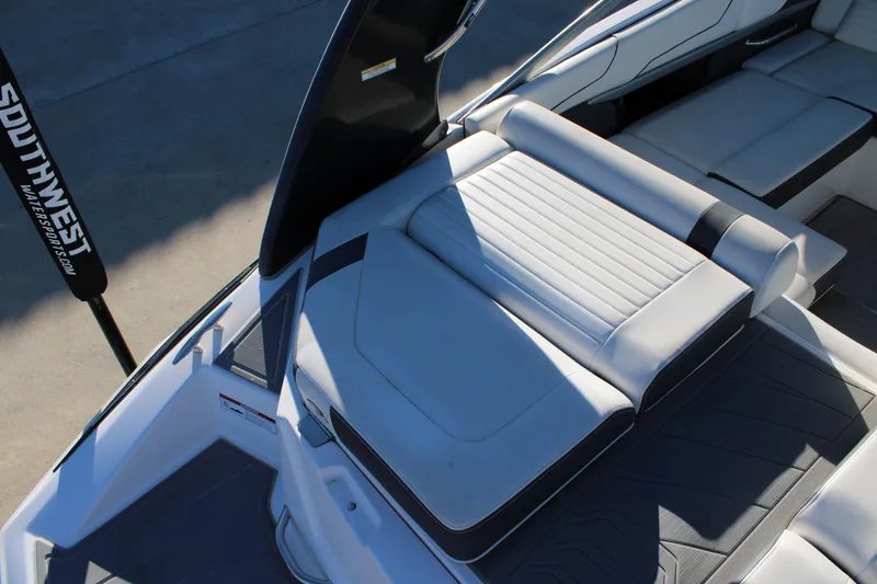 Slide: The Image of 2017 Regal 2100 Bowrider boat interior with white seating and sleek design. - 6