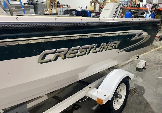 Slide: The Image of 1998 Crestliner Fish Hawk 1650 boat on trailer in workshop. - 3