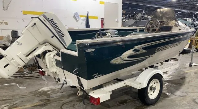 Slide: The Image of 1998 Crestliner Fish Hawk 1650 boat with Johnson outboard motor. - 6