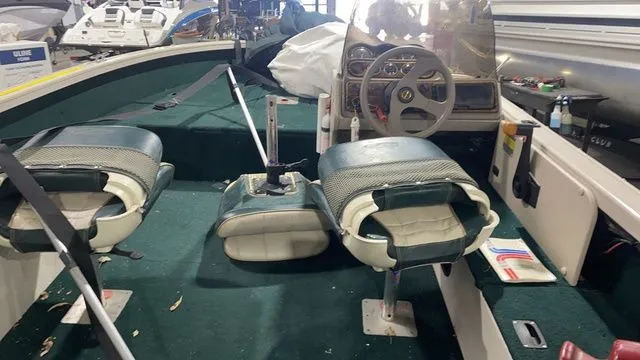 Slide: The Image of Interior of a 1998 Crestliner Fish Hawk 1650 boat with green seats. - 7