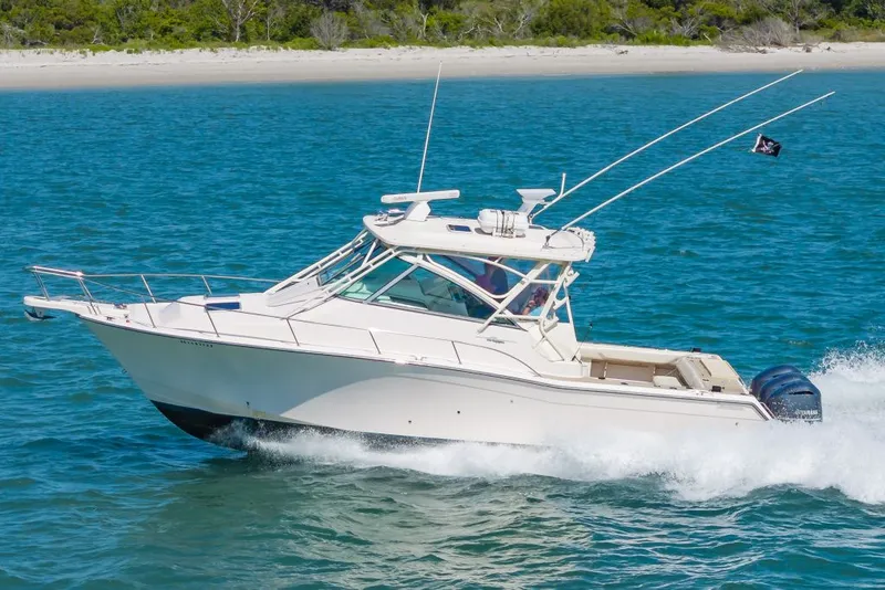 Slide: The Image of 2014 Grady-White Express 370 boat cruising on blue water. - 2