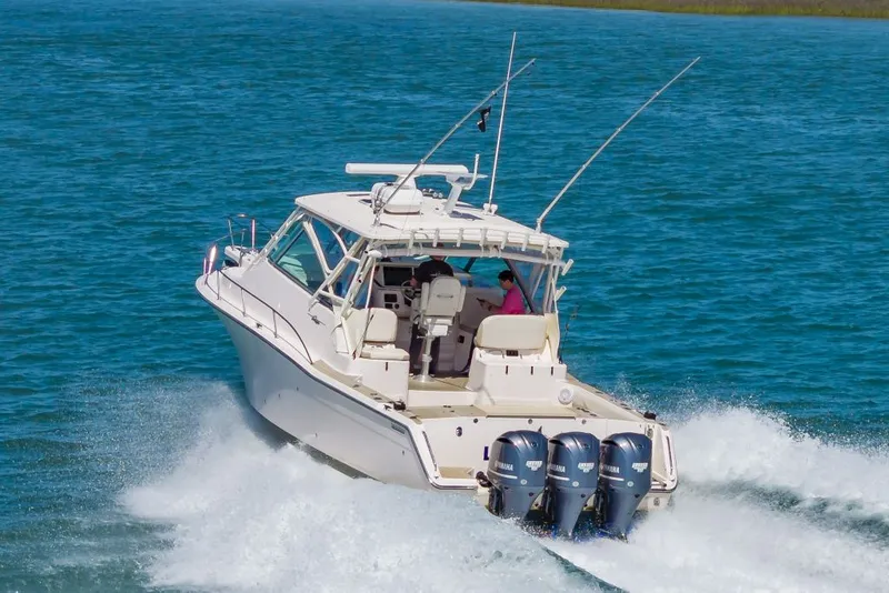 Slide: The Image of 2014 Grady-White Express 370 boat cruising on water. - 4