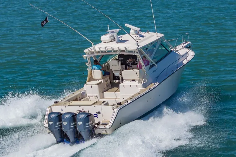 Slide: The Image of 2014 Grady-White Express 370 boat on water with triple outboard engines. - 5
