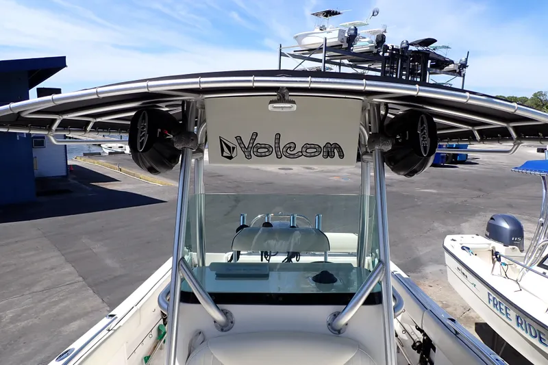 Slide: The Image of 2006 Robalo R220 Center Console boat with T-top and speakers at a marina. - 11