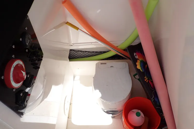 Slide: The Image of Interior of 2006 Robalo R220 Center Console with storage items and marine equipment. - 12