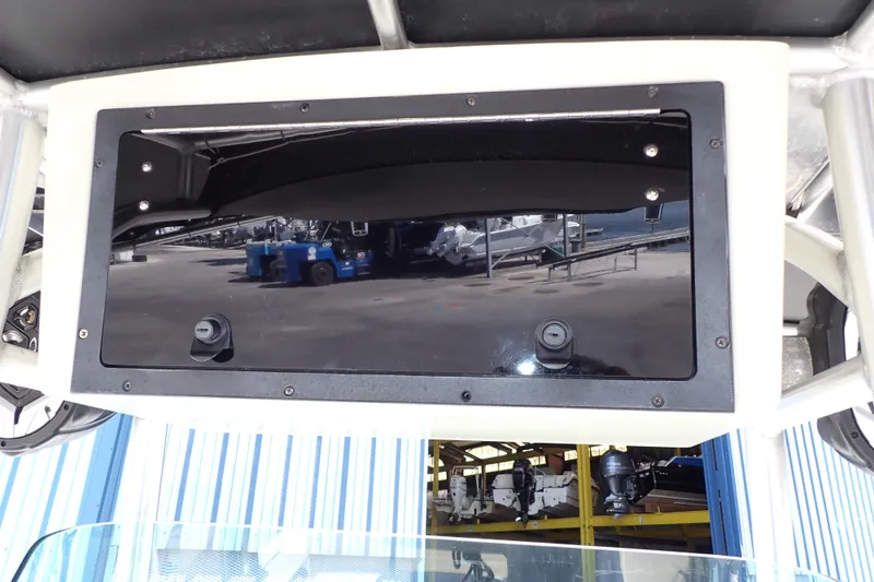 Slide: The Image of 2006 Robalo R220 Center Console boat with a black storage compartment under the console. - 18