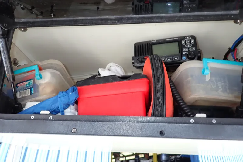 Slide: The Image of Storage compartment in a 2006 Robalo R220 Center Console boat with equipment and supplies. - 19