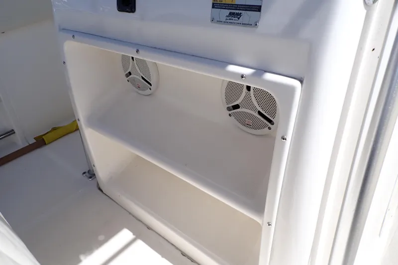 Slide: The Image of 2006 Robalo R220 Center Console boat speakers and storage compartment. - 21