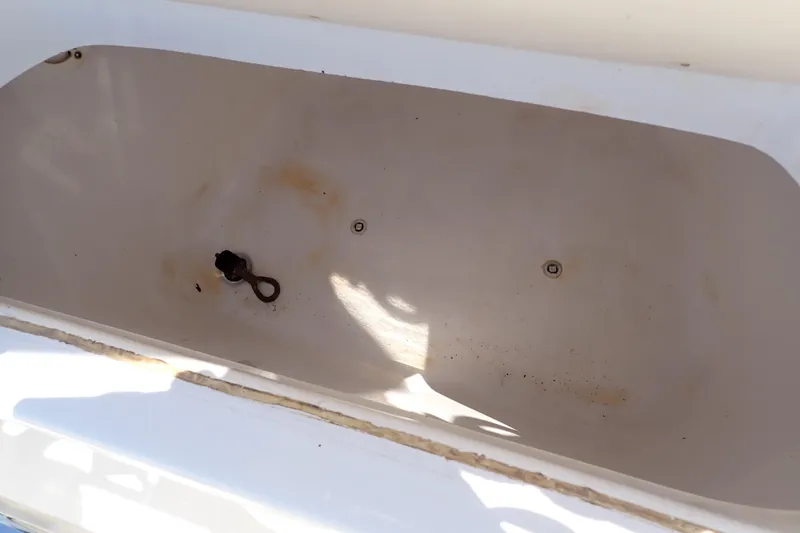 Slide: The Image of Open storage compartment in 2006 Robalo R220 Center Console boat. - 23