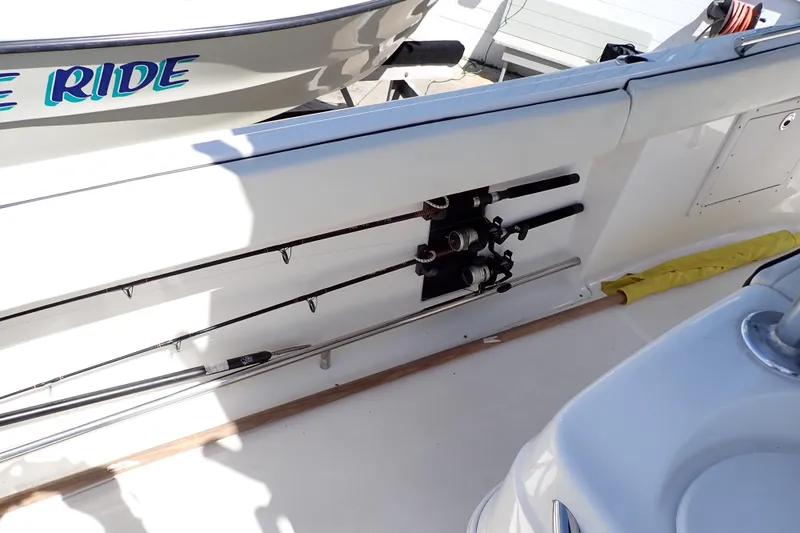 Slide: The Image of 2006 Robalo R220 Center Console boat with fishing rods stored on deck. - 24