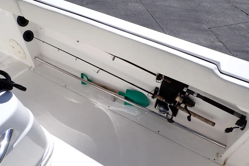 Slide: The Image of 2006 Robalo R220 Center Console boat interior with fishing rod storage. - 25