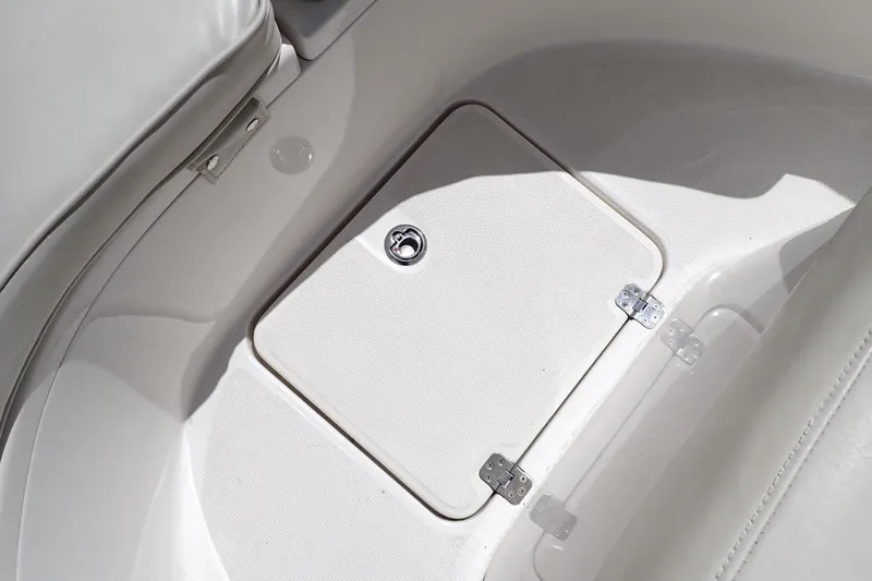 Slide: The Image of 2006 Robalo R220 Center Console boat storage compartment with secure latch and hinges. - 30