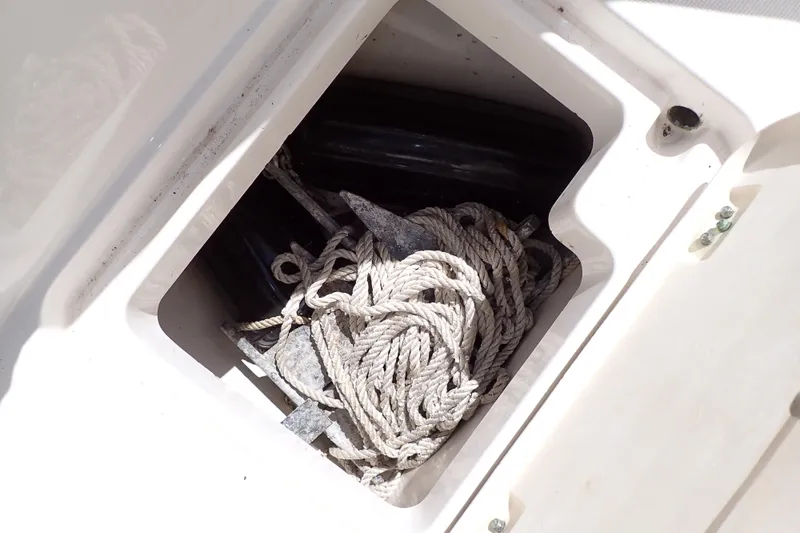Slide: The Image of Anchor and rope storage in 2006 Robalo R220 Center Console boat compartment. - 31