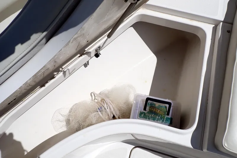 Slide: The Image of Storage compartment in a 2006 Robalo R220 Center Console boat with fishing gear. - 33