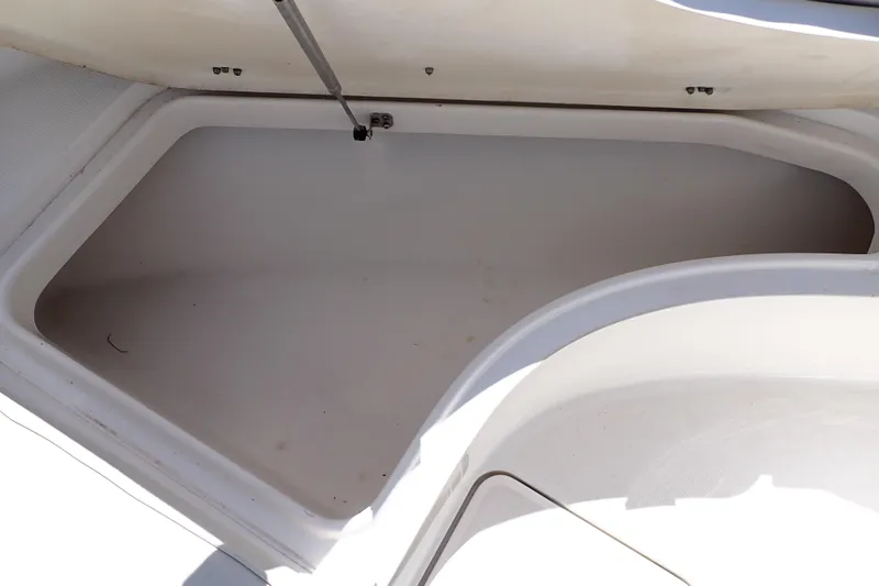 Slide: The Image of Storage compartment of a 2006 Robalo R220 Center Console boat, open and empty. - 35