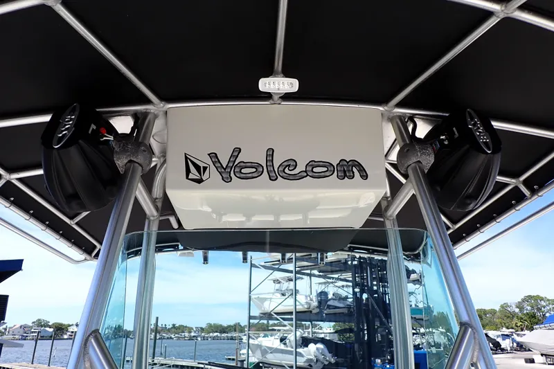 Slide: The Image of 2006 Robalo R220 Center Console boat with Volcom branding and speakers. - 36