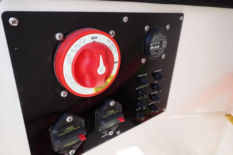 Slide: The Image of Control panel of 2006 Robalo R220 Center Console boat with switches and circuit breakers. - 40