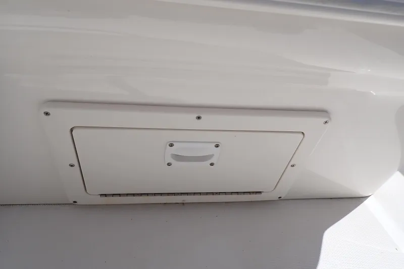 Slide: The Image of 2006 Robalo R220 Center Console storage compartment with handle, white finish. - 43