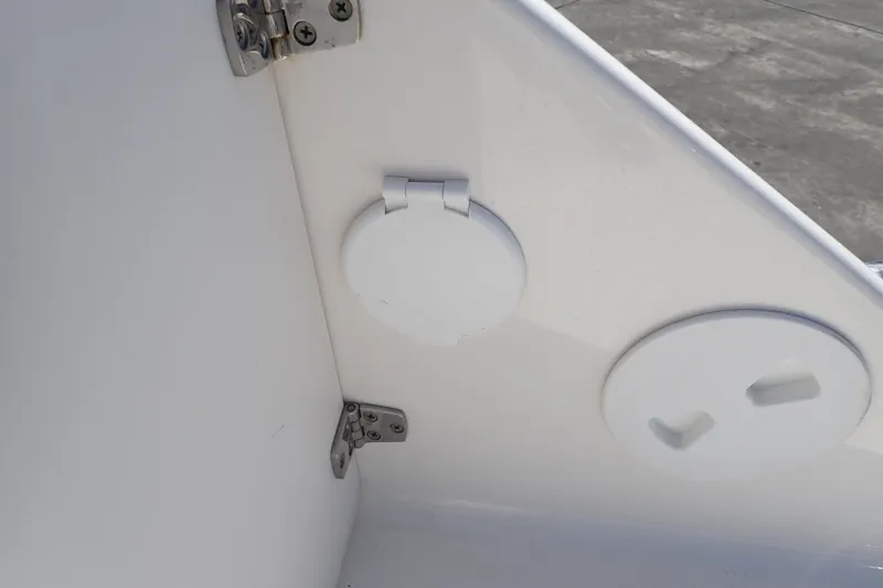 Slide: The Image of 2006 Robalo R220 Center Console boat interior detail with hinges and circular covers. - 46
