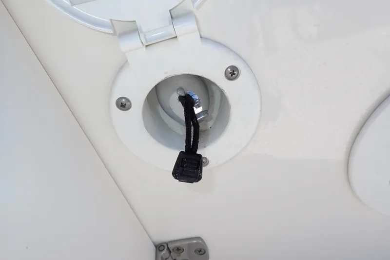 Slide: The Image of 2006 Robalo R220 Center Console boat fuel cap with tethered plug. - 47