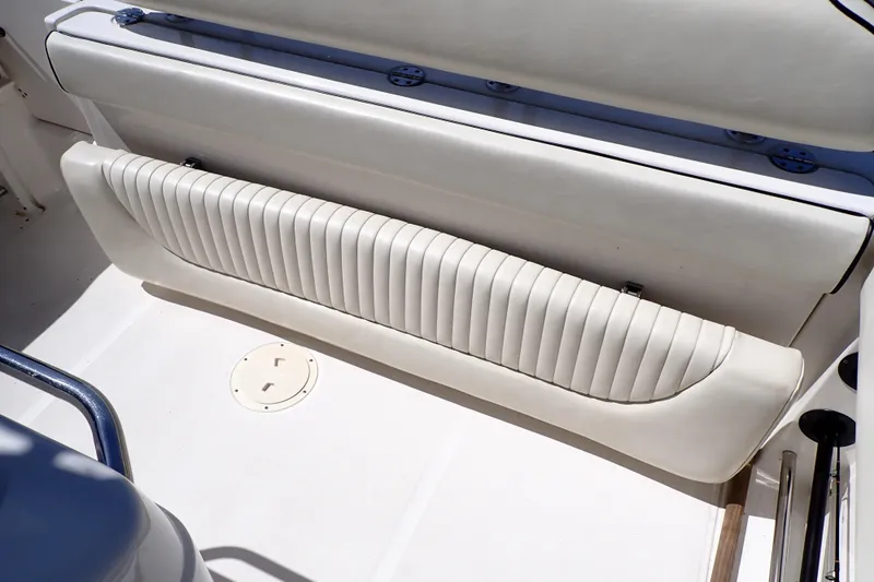 Slide: The Image of 2006 Robalo R220 Center Console boat interior with white cushioned seating. - 50