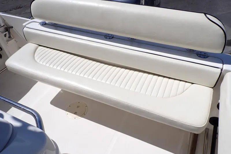 Slide: The Image of 2006 Robalo R220 Center Console boat with white cushioned seating. - 51
