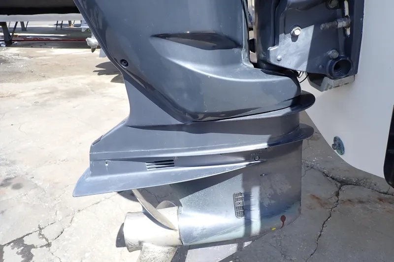 Slide: The Image of 2006 Robalo R220 Center Console boat engine close-up on concrete surface. - 57