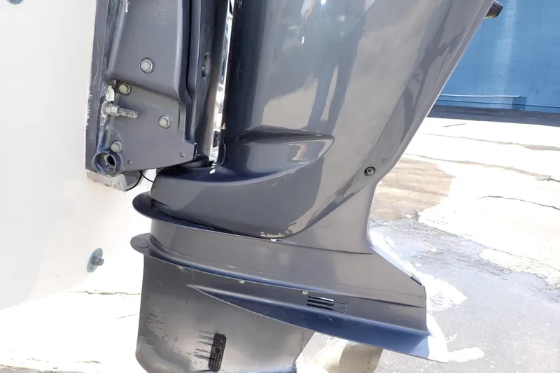 Slide: The Image of 2006 Robalo R220 Center Console boat engine close-up, showcasing sleek design and metallic finish. - 61