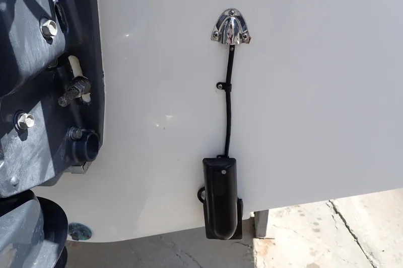 Slide: The Image of 2006 Robalo R220 Center Console boat transom with mounted sensor and hardware. - 65