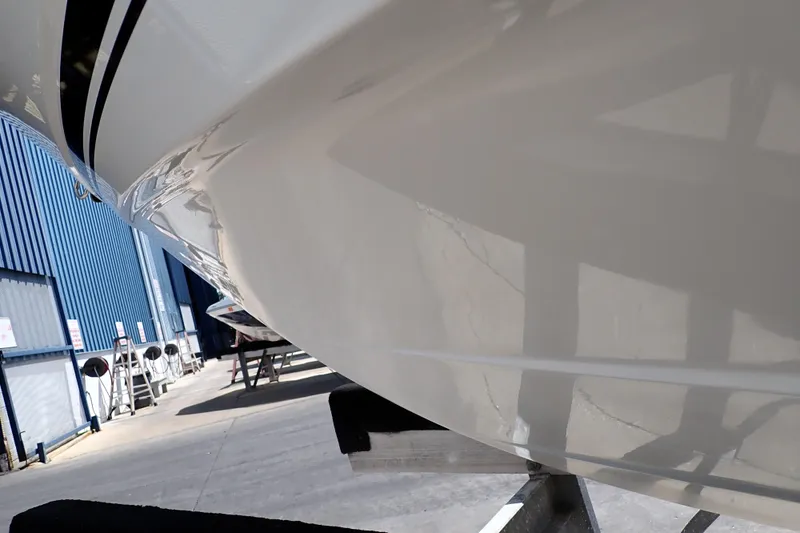 Slide: The Image of 2006 Robalo R220 Center Console boat hull in a marina setting. - 69