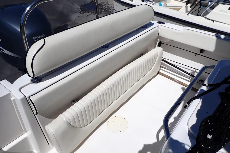 Slide: The Image of 2006 Robalo R220 Center Console boat interior with cushioned seating and Yamaha engine. - 7