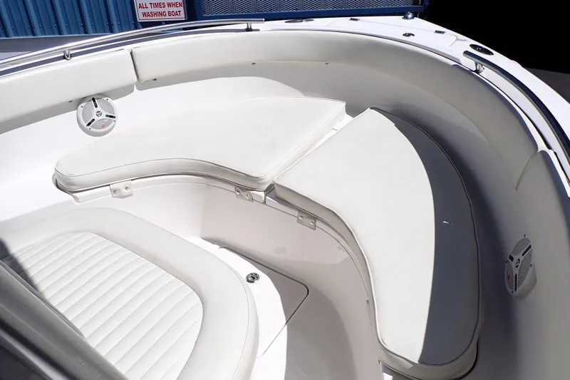 Slide: The Image of 2006 Robalo R220 Center Console boat interior with cushioned seating and speakers. - 9