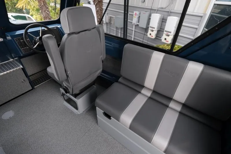 Slide: The Image of Interior of 2026 Hewescraft 240 Ocean Pro ET Hardtop, featuring seating and steering area. - 11