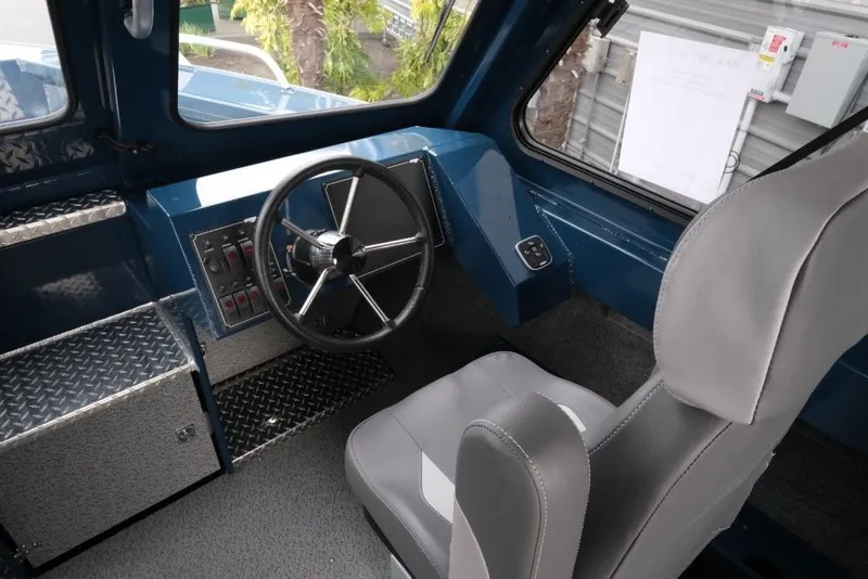 Slide: The Image of Interior of 2026 Hewescraft 240 Ocean Pro ET Hardtop, featuring steering wheel and controls. - 12