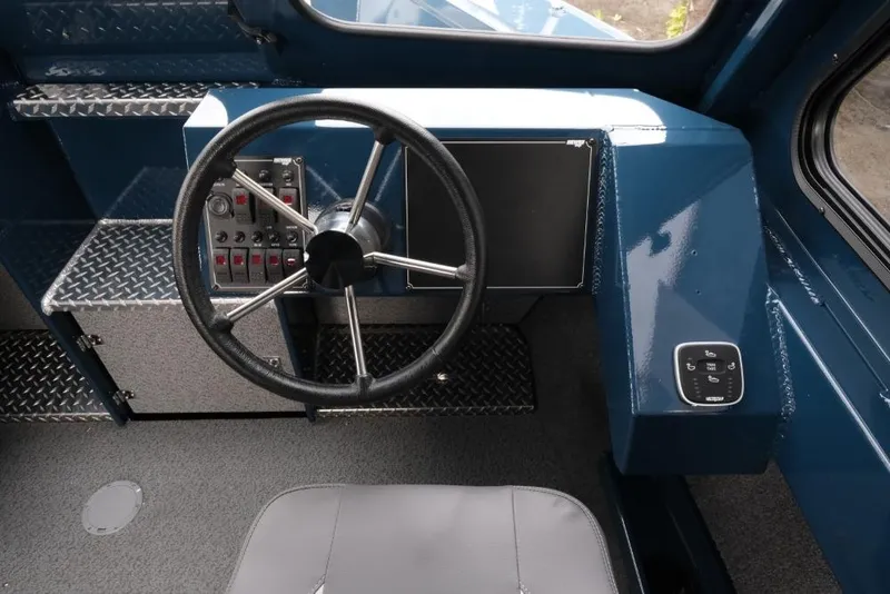 Slide: The Image of 2026 Hewescraft 240 Ocean Pro ET Hardtop interior with steering wheel and control panel. - 13