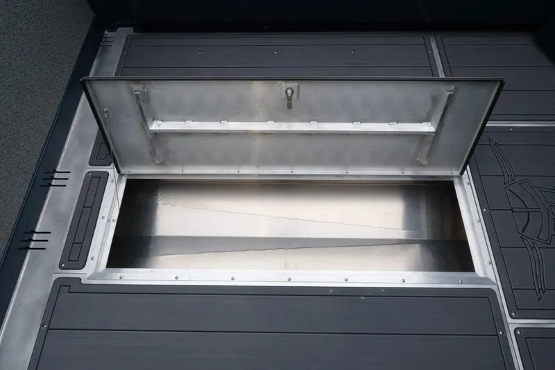 Slide: The Image of Open storage compartment on 2026 Hewescraft 240 Ocean Pro ET Hardtop boat deck. - 17