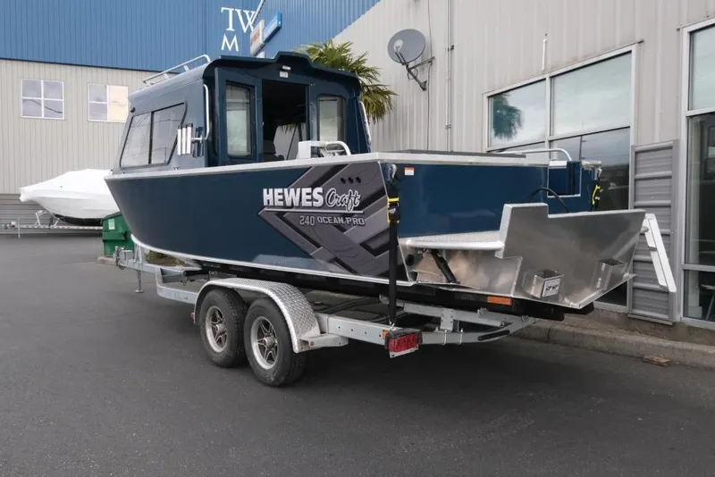 Slide: The Image of 2026 Hewescraft 240 Ocean Pro ET Hardtop boat on trailer, parked outside a building. - 4