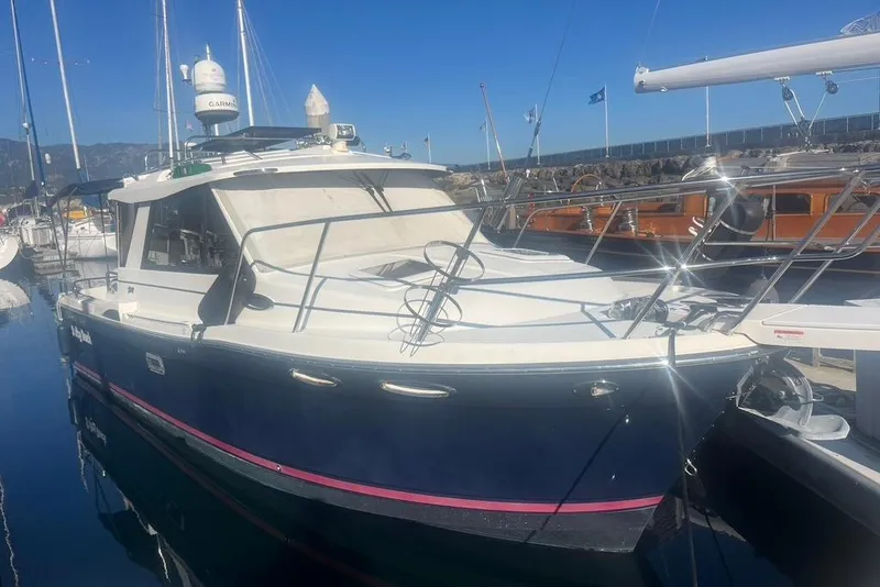 The Image of 2013 Cutwater C-28 boat docked in a marina, featuring a sleek design and modern equipment. - 0